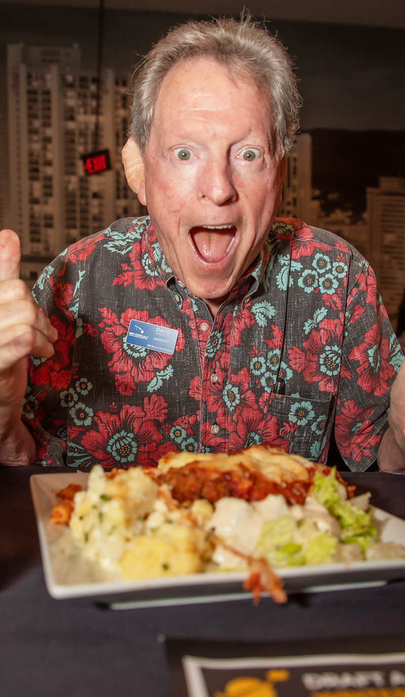 SME Honolulu member David Livingston reacts with excitement to a plated dinner at a networking event.