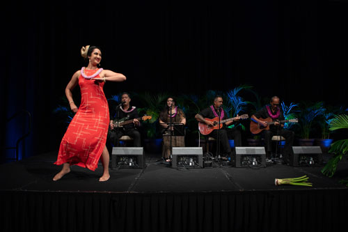 Hawaiian hula dancer performing on stage with live musicians at SME Honolulu SPOY banquet event in Waikiki Honolulu Hawaii, featuring cultural entertainment, live music, and business networking