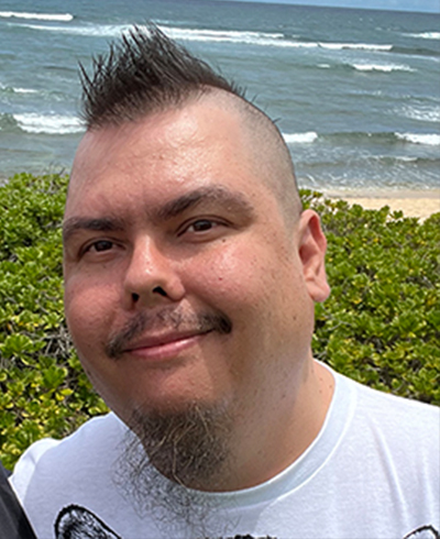 Richard Scheffer, SME Honolulu Board of Directors member, in a professional portrait with a teal background.