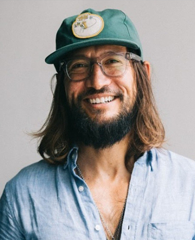 Sam Frentzel-Beyme, SME Honolulu Board of Directors member, in a professional portrait with a teal background.